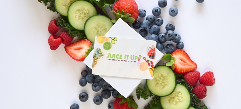 Juice it up gift card, slices of fruit and vegetables